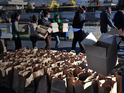 volunteers carry boxes of  food for the food pantry