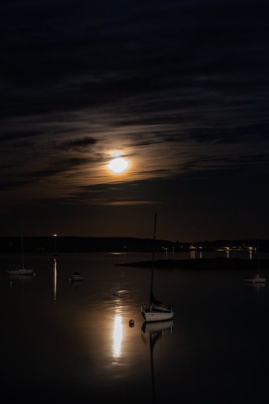 night imagery of the moon over Casco Bay