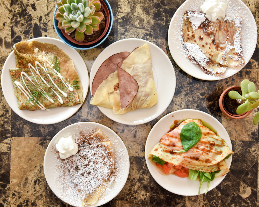 Restaurant table with a variety of crepes from Sip of Europe
